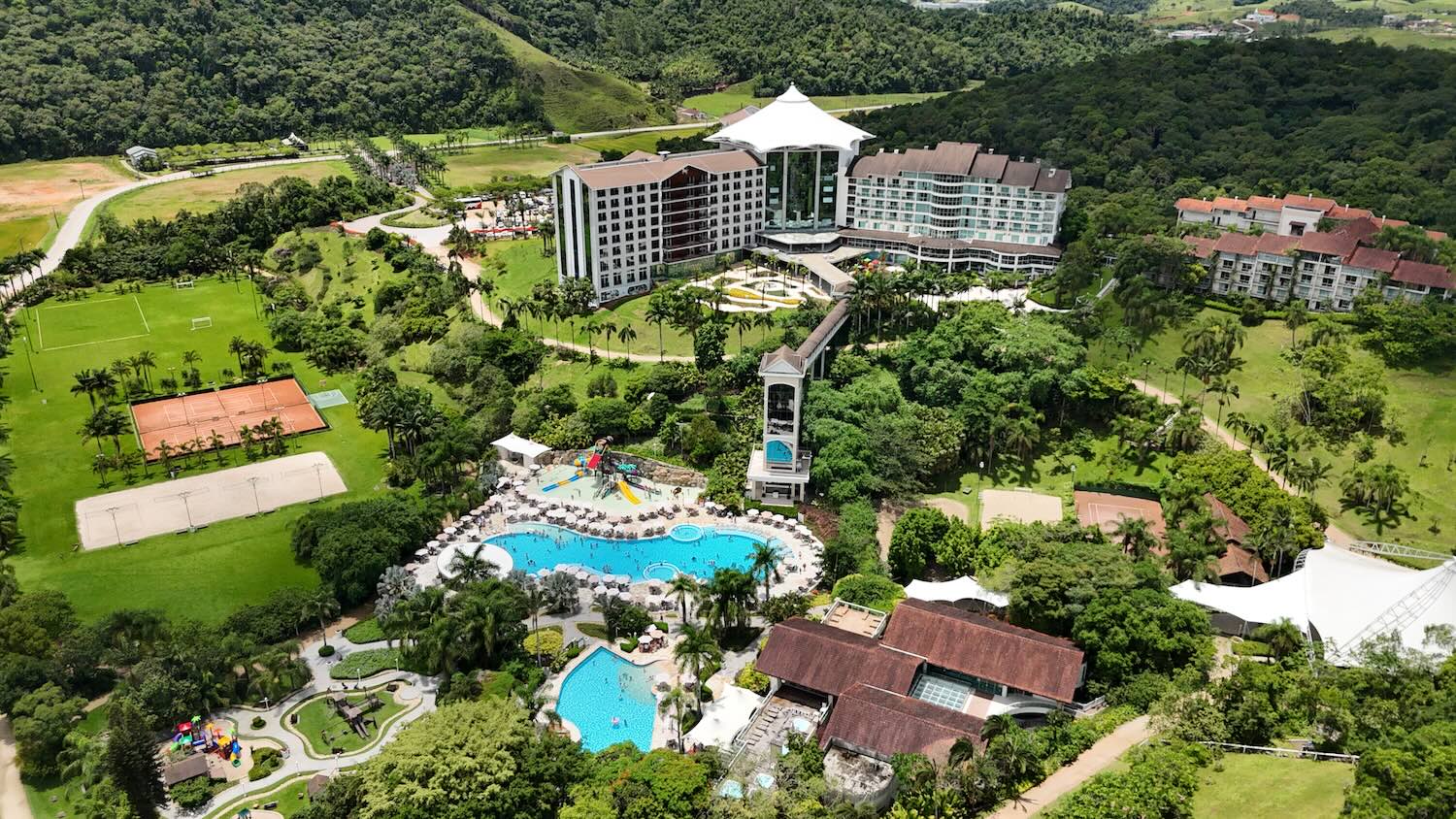 estrutura completa de resort, com piscinas, jardins e prédios